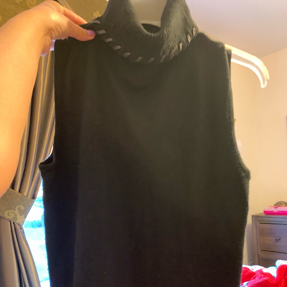 Black sleeveless light sweater .Fits like a small